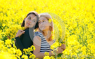 Two beautiul girls having fun in the colza field Stock Photo
