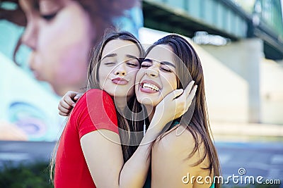 Two best female friends embracing together Stock Photo