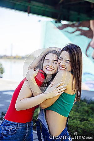 Two best female friends embracing together Stock Photo