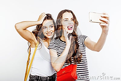 Two best friends teenage girls together having fun, posing emotional on white background, besties happy smiling, making Stock Photo