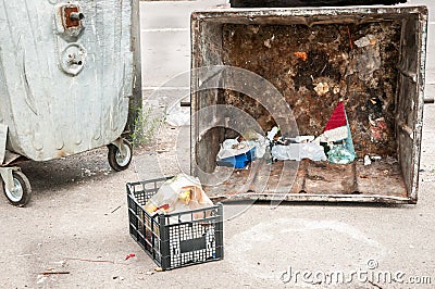 Two big old metal dumpster garbage cans with junk on the street damaged by vandals, vandalism concept Stock Photo