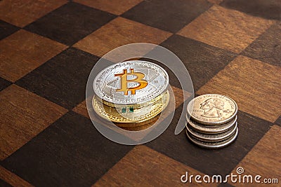 Two Bitcoins and American cents on a chessboard Stock Photo