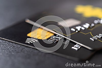 Two black debit cards for cash withdrawals and money transfers. Credit cards with chip and contactless technology macro. Bank Editorial Stock Photo