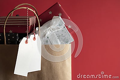 Two blank tags and a bag full of gifts Stock Photo
