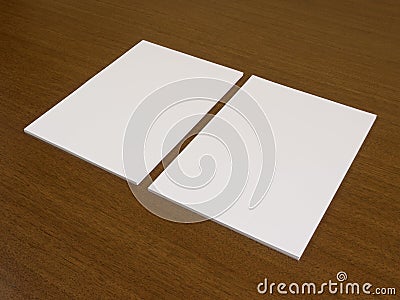 Two blank white papers on a wooden background Stock Photo