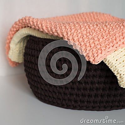 Two blankets and basket on white table Stock Photo