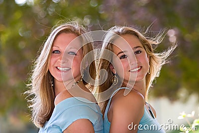 Two Blond Teen Girls Back-To-Back Stock Photo