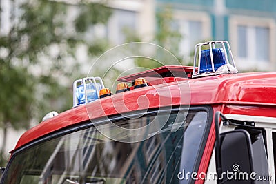 Two blue flashing lights on the roof of fire truck Stock Photo