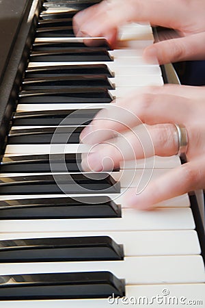 Two blured hands play the piano Stock Photo