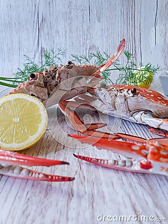 Two Boiled crabs with lemon and dill on wood Stock Photo
