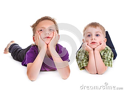 Two bored kids lying on the white Stock Photo