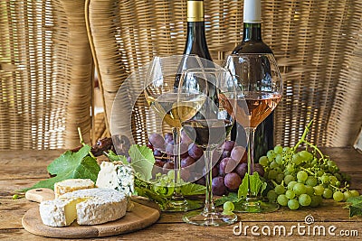 Two bottle of wine and three glasses of white, pink and red wine Stock Photo