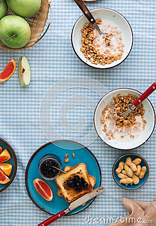 Two bowl muesli with yogurt, fruits, toasts with copy space Stock Photo