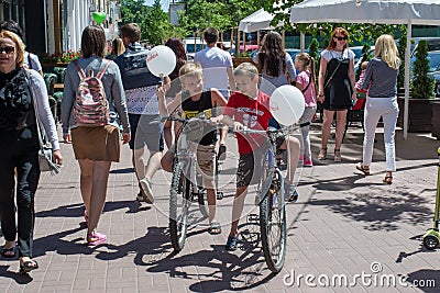 Two boys on the bicycles with baloons during children protection day Editorial Stock Photo