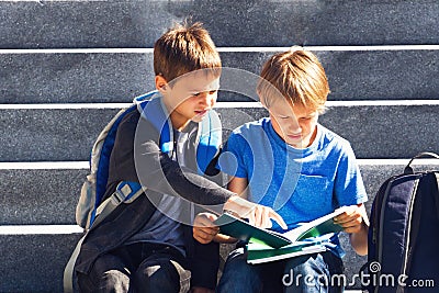 Two boys doing homework outdoors. Back to school concept. Stock Photo