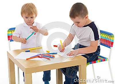 Two boys enthusiastically paint markers Stock Photo