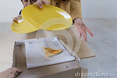 Children are asked to give them the last piece of pizza 4 cheeses remaining in the box after a family dinner Stock Photo