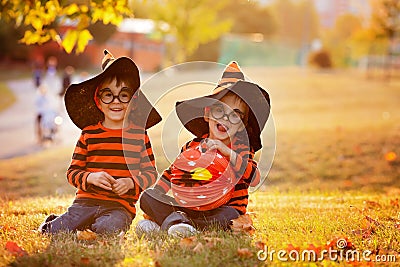 Two boys in the park with Halloween costumes Stock Photo