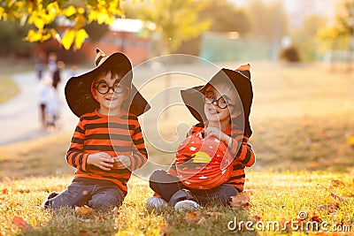 Two boys in the park with Halloween costumes Stock Photo