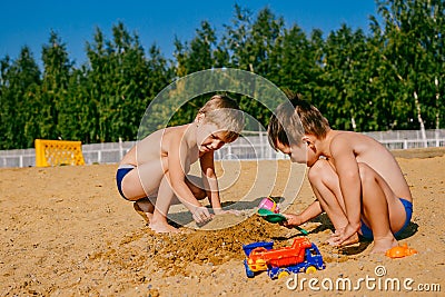 Two boys playing in the sand Stock Photo