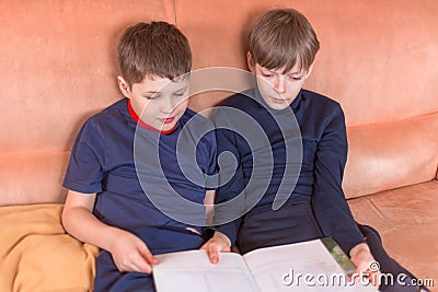 Two boys reading book Stock Photo