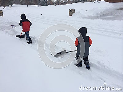 Two boys shoveling snow Editorial Stock Photo