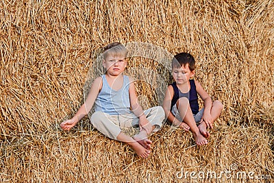 Two boys sit on the big barn Stock Photo