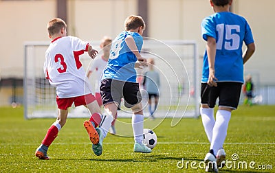 Two boys soccer teams competing for the ball during a football match Editorial Stock Photo