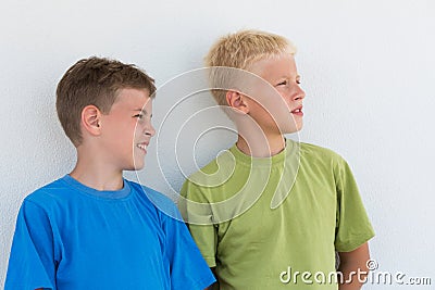 Two boys in T-shirts somewhere looking Stock Photo