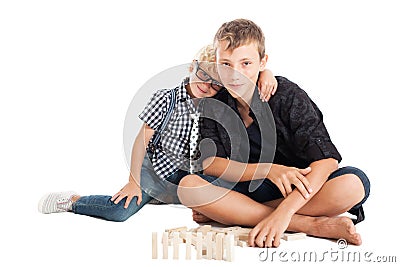 Two boys with wooden bricks Stock Photo