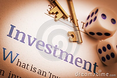 Two brass keys and dices on a fundamental investment document. Stock Photo