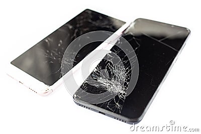 Two broken phones of white and black on a white background. cracked touchscreen glass of the touch screen isolate Stock Photo