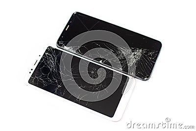Two broken phones of white and black on a white background. cracked touchscreen glass of the touch screen isolate Stock Photo
