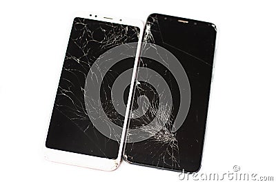 Two broken phones of white and black on a white background. cracked touchscreen glass of the touch screen isolate Stock Photo