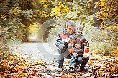 Two brothers in autumn park Stock Photo