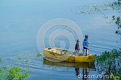 Two brothers young boy and a small child fishing alone with th Editorial Stock Photo