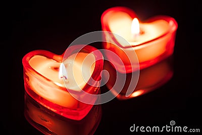 Two burning candle hearts Stock Photo