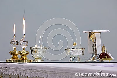 two burning church candles and ostensory on the table Stock Photo