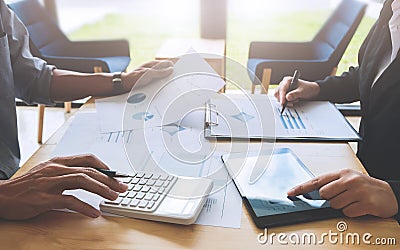 Two business colleagues discussing about data research of stock market in modern office. Stock Photo