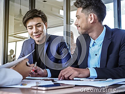 Two business colleagues working on a tablet computer in an office Stock Photo