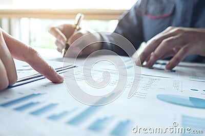 Two Business man or accountant working Financial investment, writing report Analyze business and market growth and pointing on Stock Photo