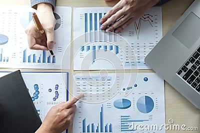 Two Business man or accountant working Financial investment, writing report Analyze business and market growth and pointing on Stock Photo