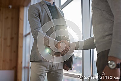 Two Business Man Shake Hand Agreement Coworking Center Business Team Coworkers Stand in front Big Panoramic Window Stock Photo