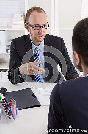 Two business men sitting in the office: meeting or job interview Stock Photo