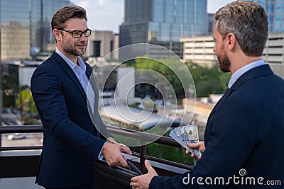 Two business team men. Negotiation for the two business men. Businessman growth strategy. Businessmen giving money Stock Photo