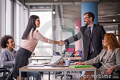 Two business teams successfully negotiating, shaking hands. Stock Photo