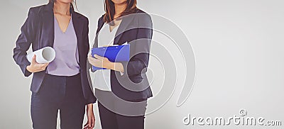 Two business women industrial engineers helmets with a tablet in Stock Photo