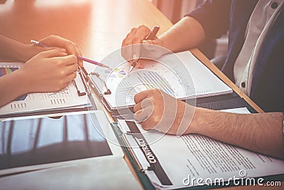 Two business worker are consulting on company data document Stock Photo