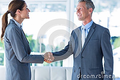 Two business workers shake hands Stock Photo