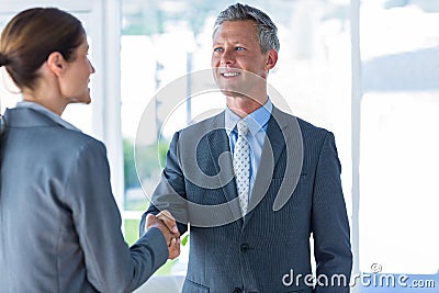 Two business workers shake hands Stock Photo